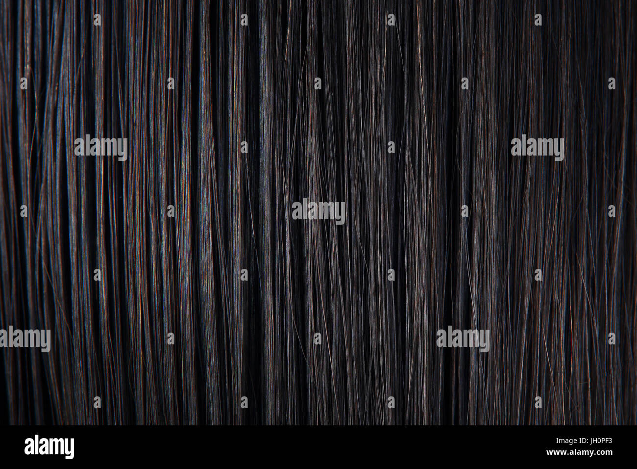 Straight black hair close-up. Texture of dark woman hair. Black female hair background. Stock Photo