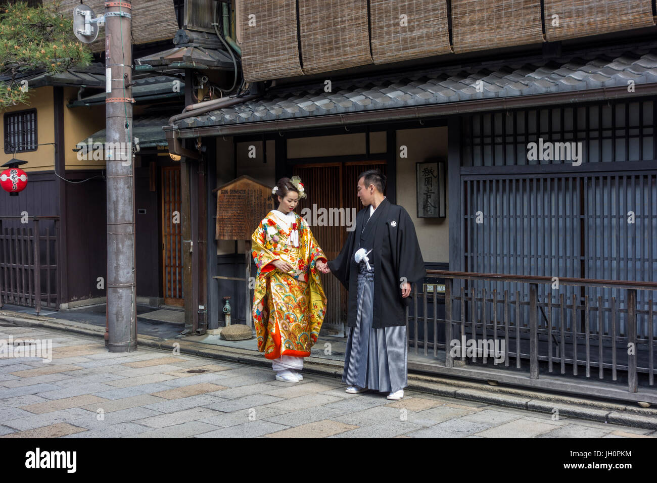 Japanese couple dressed in traditional costume, having their photographs taken a few days before the actual wedding. Stock Photo