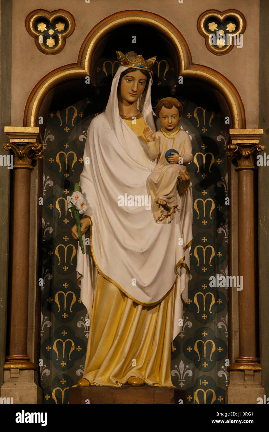 Virgin and child statue in a niche in a catholic church. Paris. France. Stock Photo