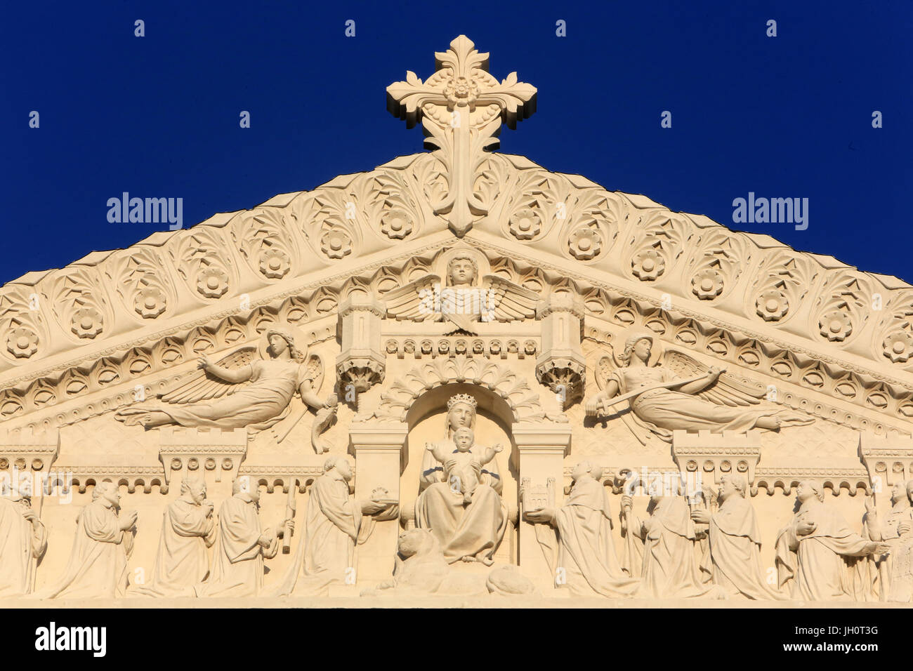 Homage of the dignitaries to the Virgin and Child. Pediment. Basilica of Notre-Dame de Fourvire. Lyon. Stock Photo