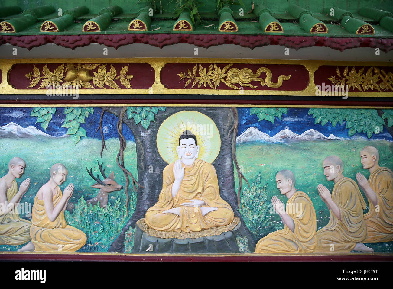 Buddhist temple. Thien Minh Pagoda. Shakyamuni Buddha. The first discourse. The Buddha preaching the sermon - the wheel of law - to his five disciples Stock Photo
