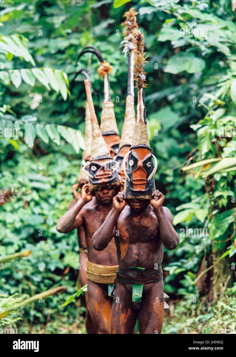 Tribesmen Dancing In The Jungle With Helmet Masks For A Circumcision tribesmen-dancing-in-the-jungle-with-helmet-masks-for-a-circumcision