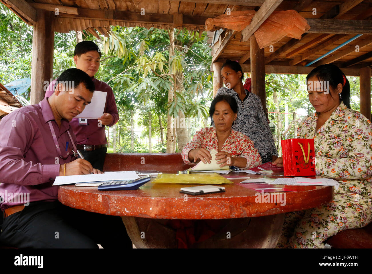 Repayment of a group loan collected by employees of AMK microfinance.  Cambodia. Stock Photo