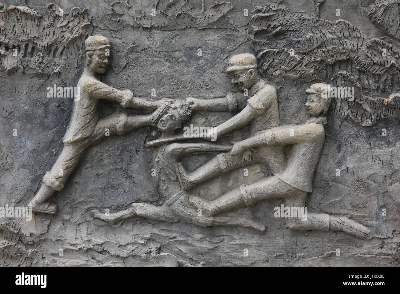 Memorial shrine festooned with bas-reliefs of Khmer Rouge atrocities at Wat Somrong Knong. Cambodia. Stock Photo