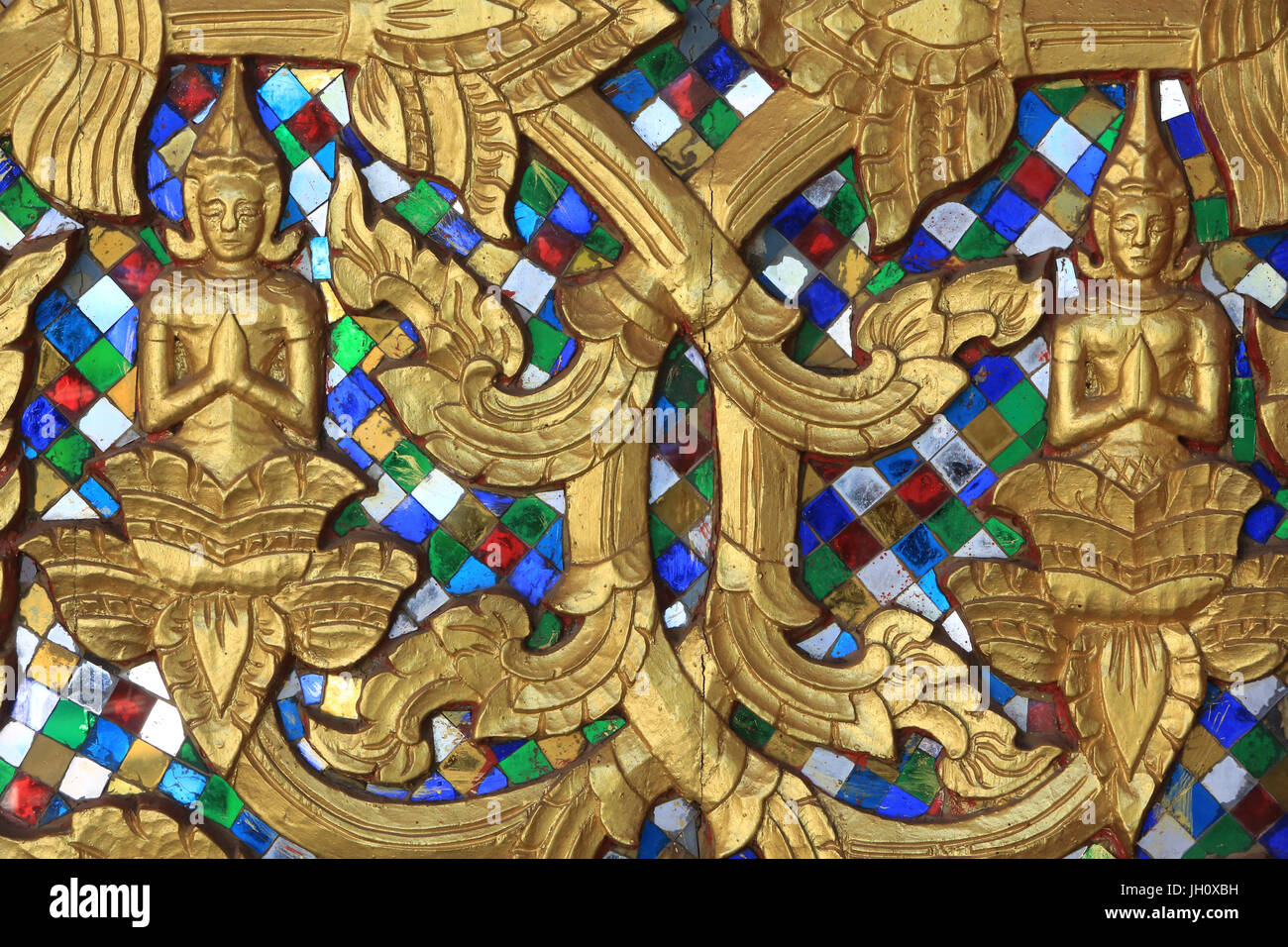 Entrance door ornamented with gold reliefs. Wat Inpeng. Ventiane. Laos. Stock Photo