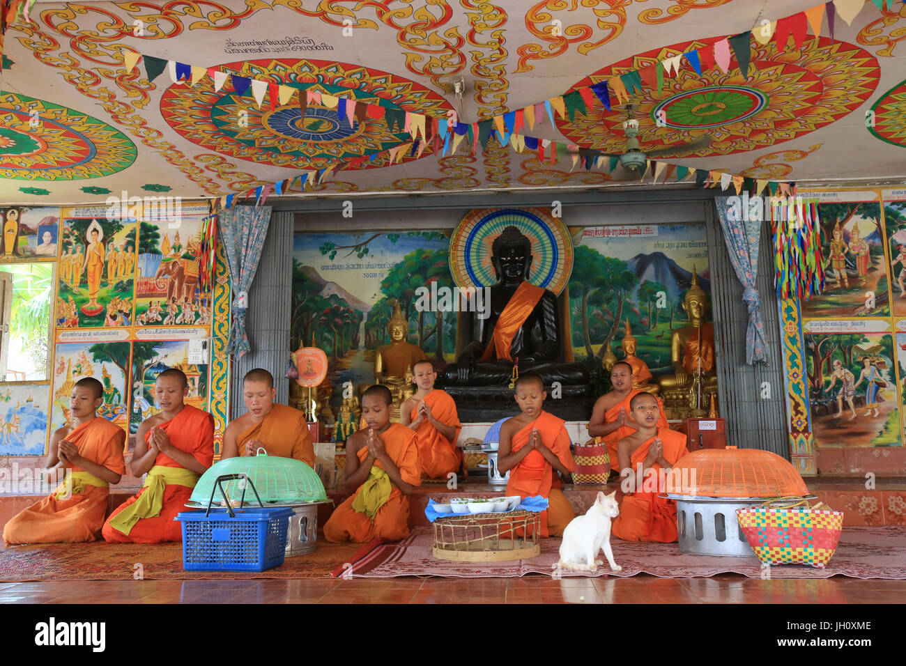Buddhist monks having lunch in monastery. Wat Kang. Vieng Vang. Laos. Stock Photo