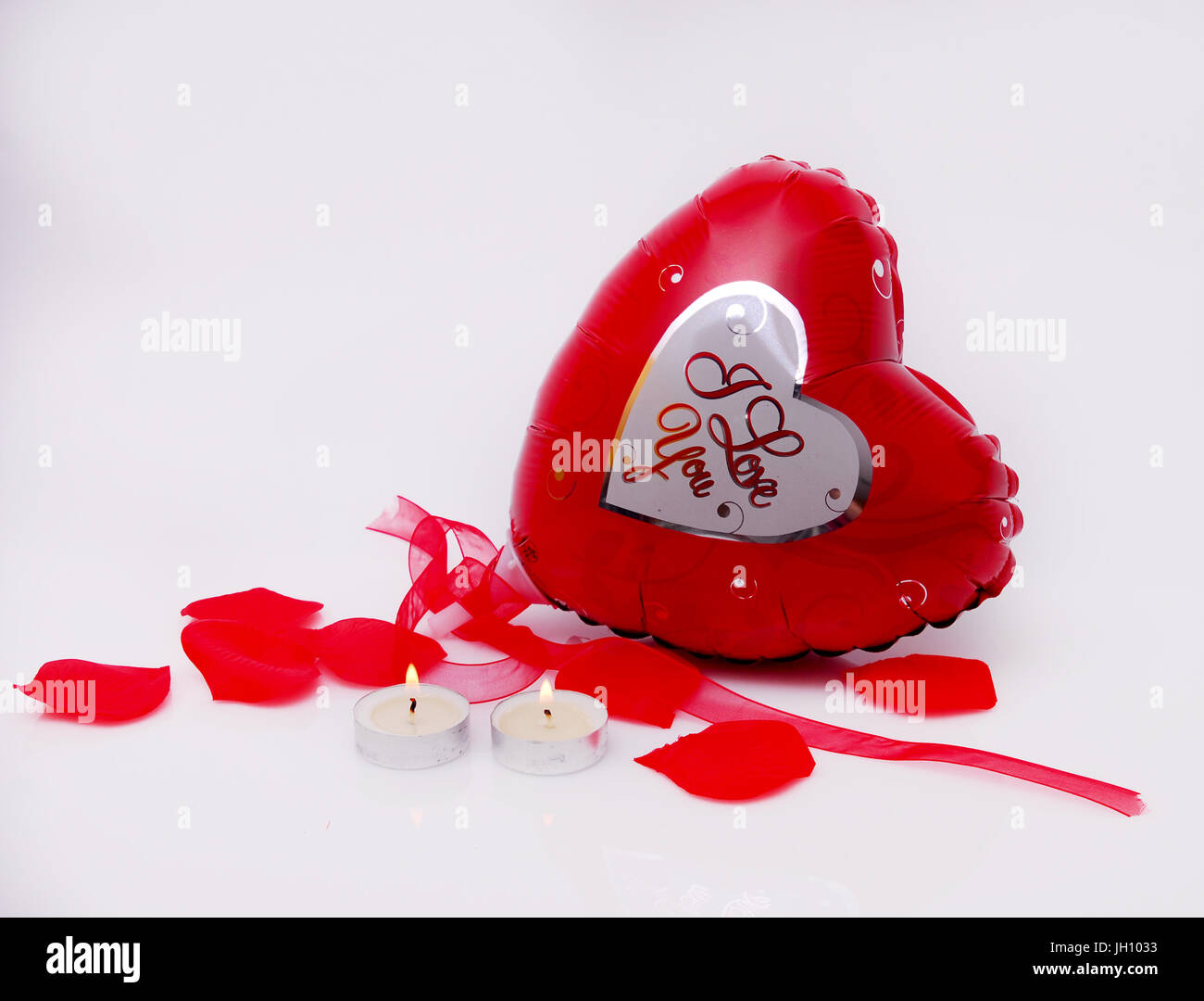valentines day heart balloon, pedals and candles Stock Photo