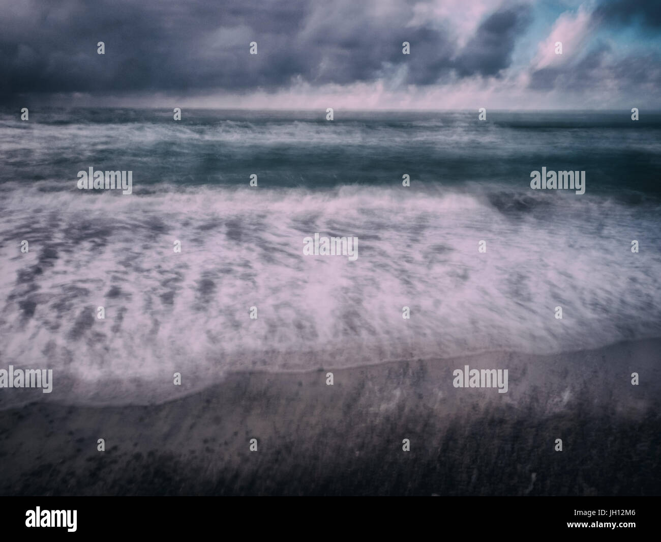 Moving Waves and clouds at Slette beach in Thy, Denmark Stock Photo
