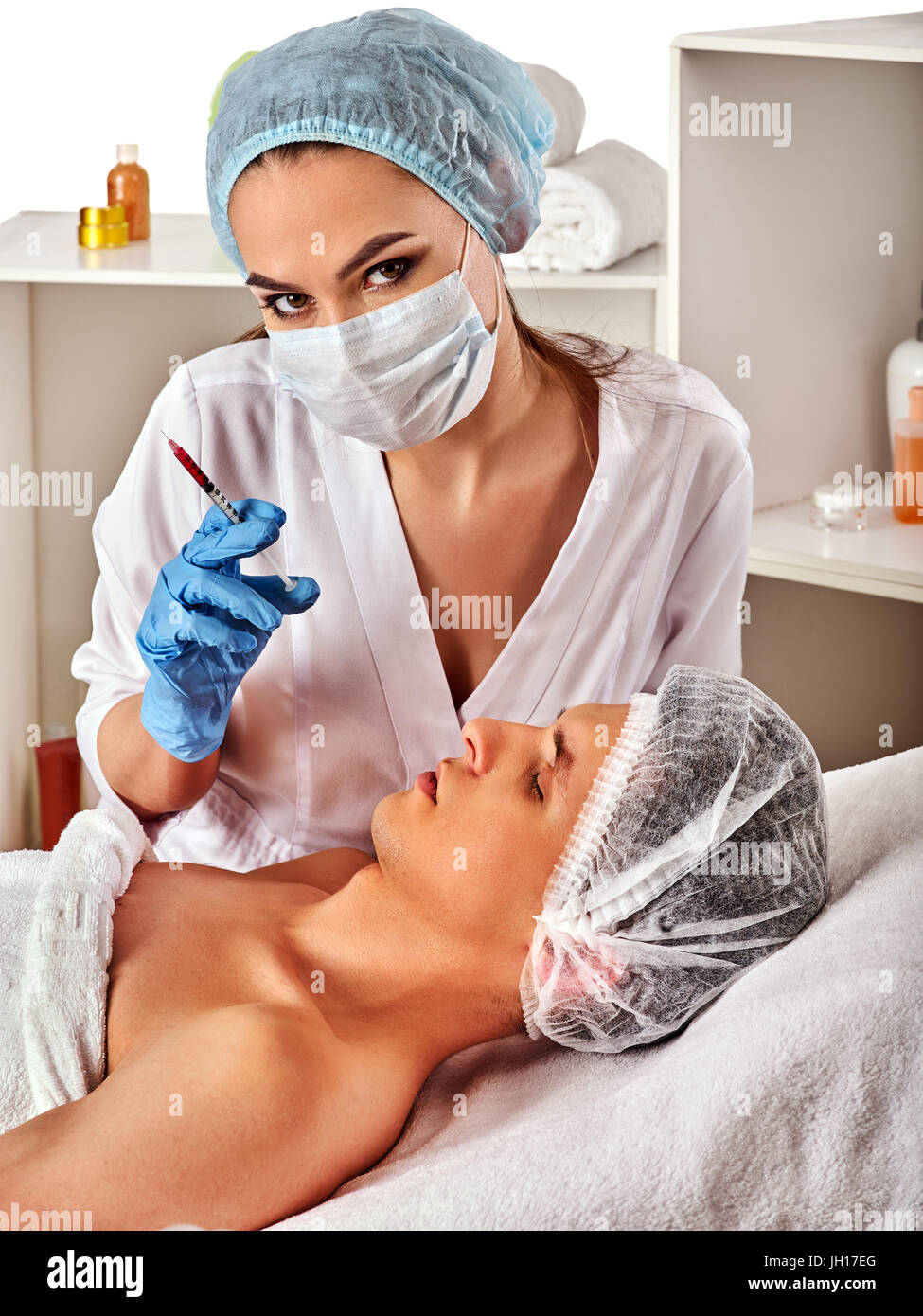 Dermal fillers of man in spa salon with beautician. Stock Photo