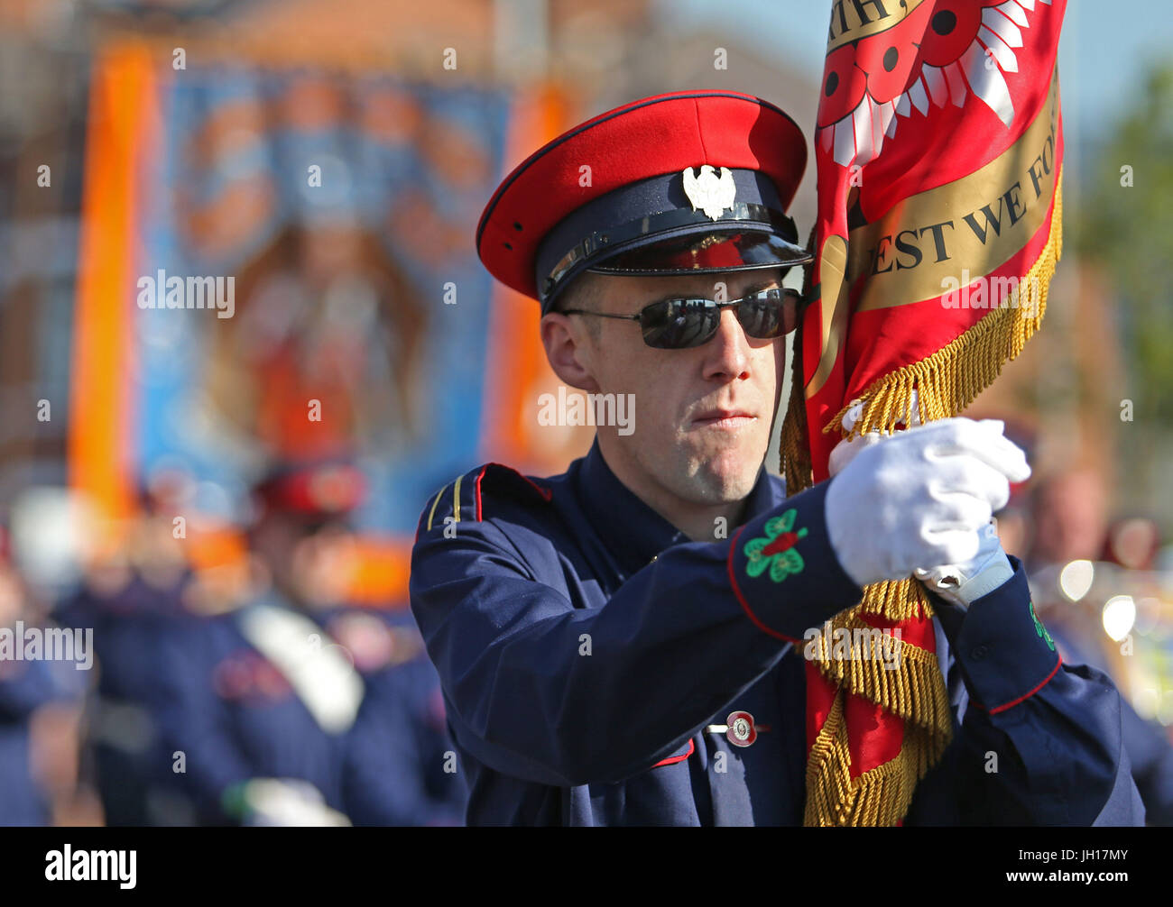 Orange Order members march past Ardoyne shops on the Crumlin Road in