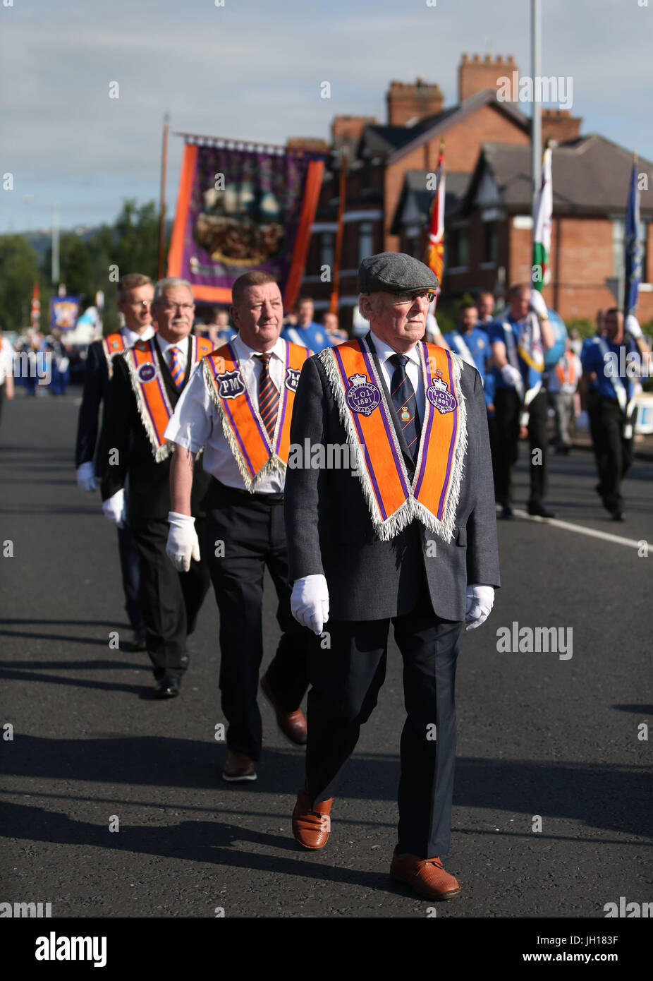 Orange Order members march past Ardoyne shops on the Crumlin Road in