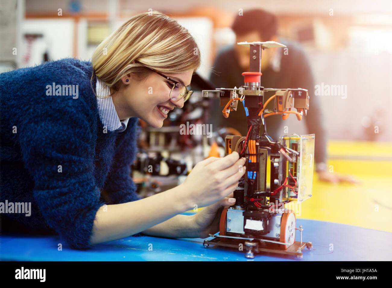 Young engineer testing her robot in workshop Stock Photo
