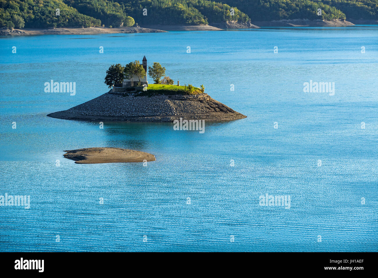 Saint-Michel Chapel and Serre-Poncon Lake in summer. Saint-Michel Bay, Hautes-Alpes, PACA Region, Southern French Alps, France Stock Photo