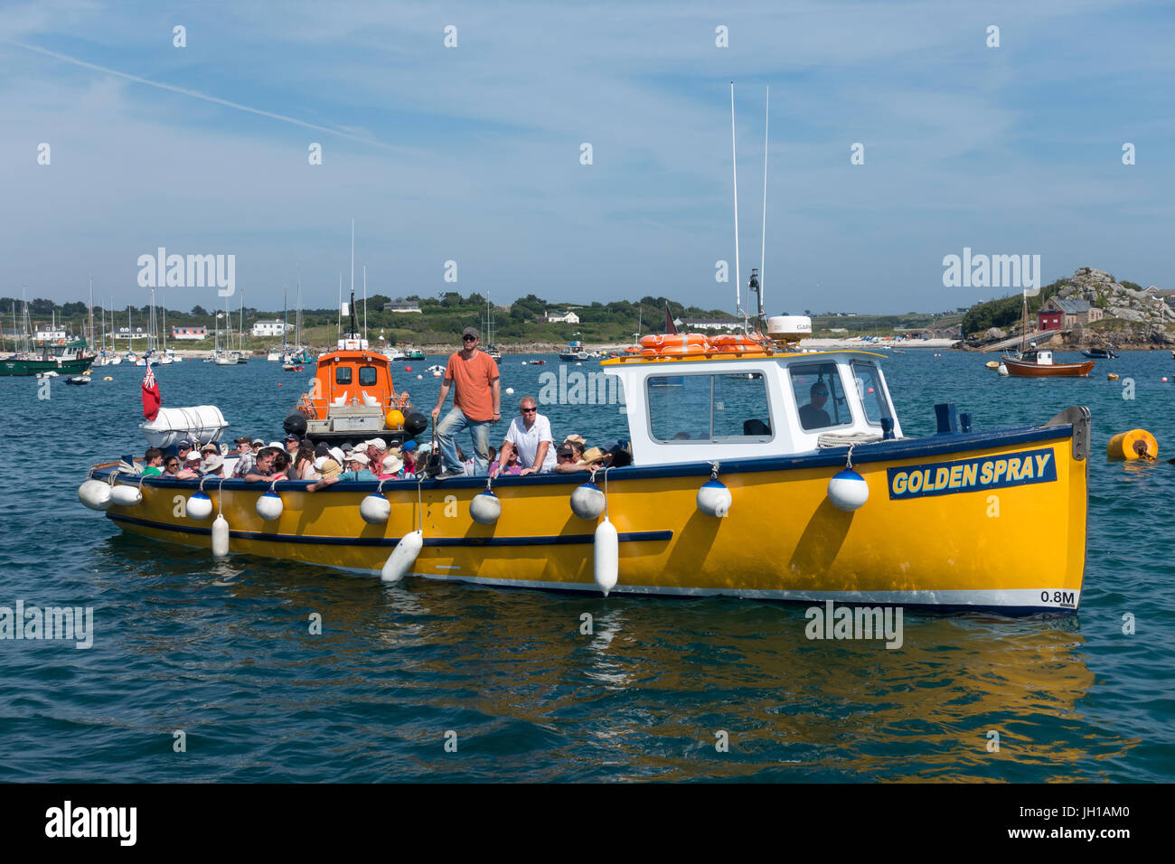 Golden Spray tripper boat in the Isles of Scilly bringing tourists back to St. Mary's from an off island trip. Stock Photo