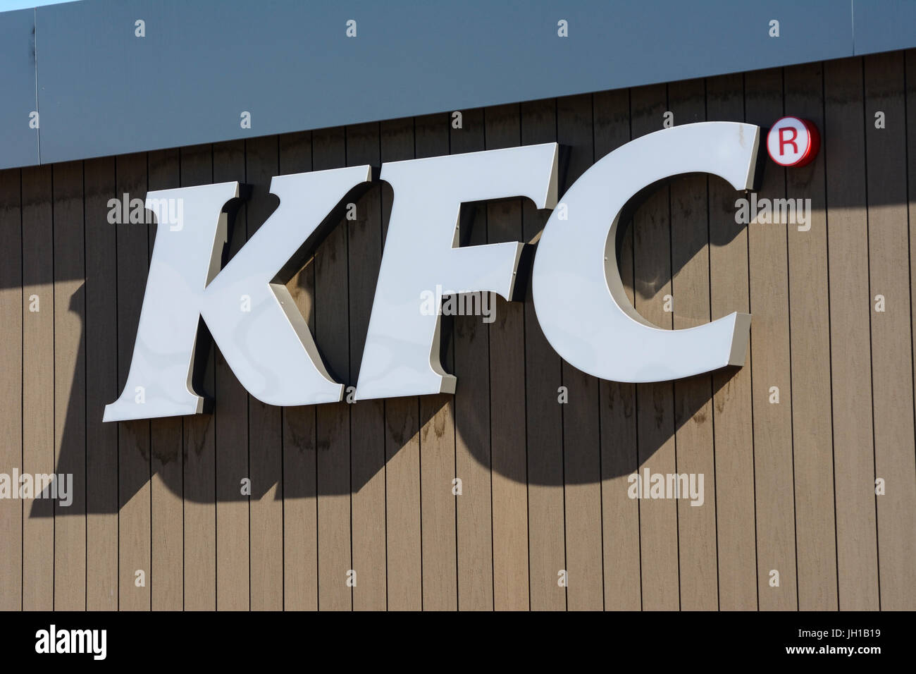 Kentucky Fried Chicken sign on the side of a KFC restaurant in Warington, Cheshire. Stock Photo