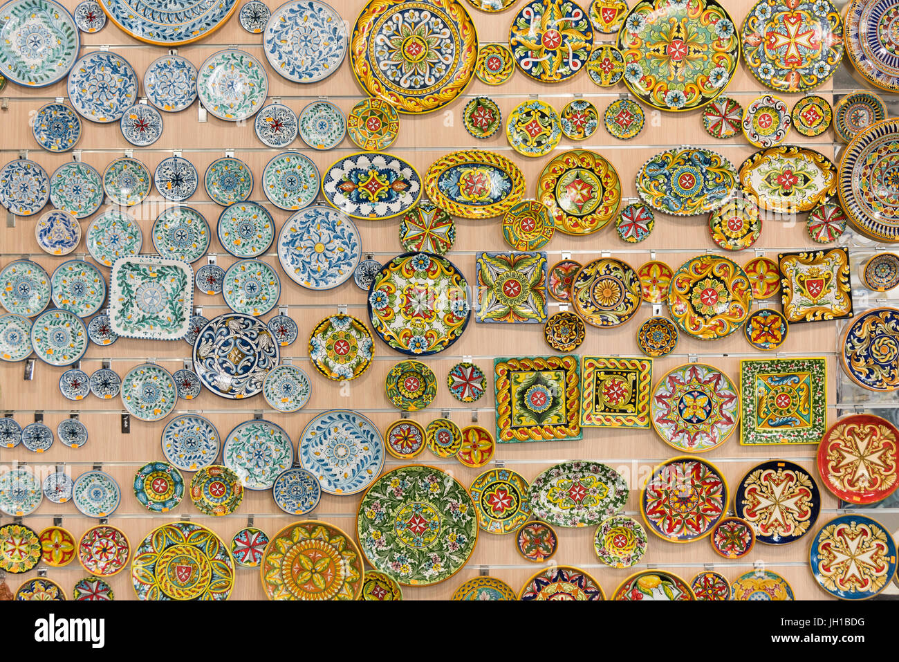 Ceramic plates for sale on a wall in a craft shop at the artisan village and Ta' Qali Crafts