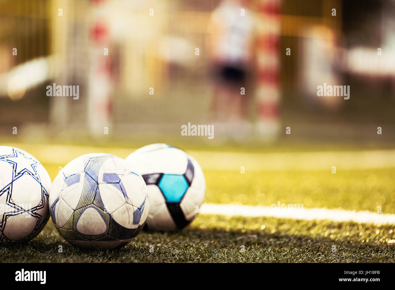 Soccer balls on football pitch Stock Photo Alamy