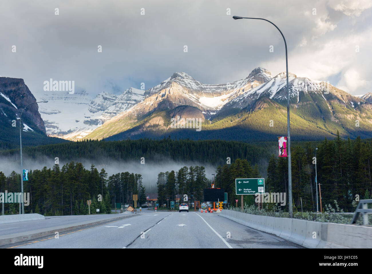 View on the town of Lake Louise just after sunrise, as seen from the viaduct over Highway 1. Lake Louise, Banff National Park, Alberta, Canada Stock Photo