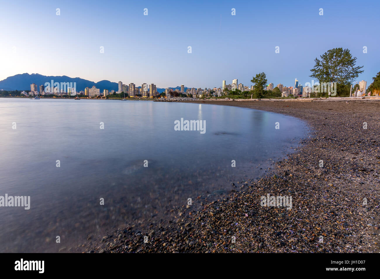 Vancouver skyline at blue hour as seen from Kitsilano beach Stock Photo