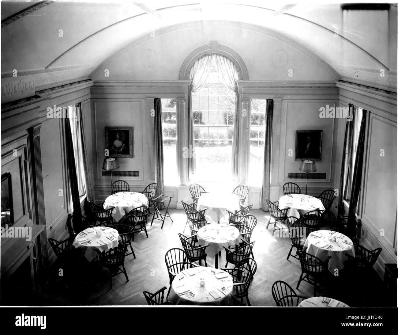 Dining room of the Johns Hopkins Club, containing many round tables set