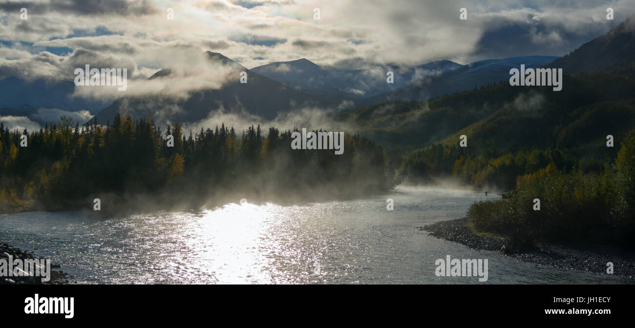 A lone fisherman has a line out in the morning mist blanketing the Russian River in south central Alaska. Stock Photo