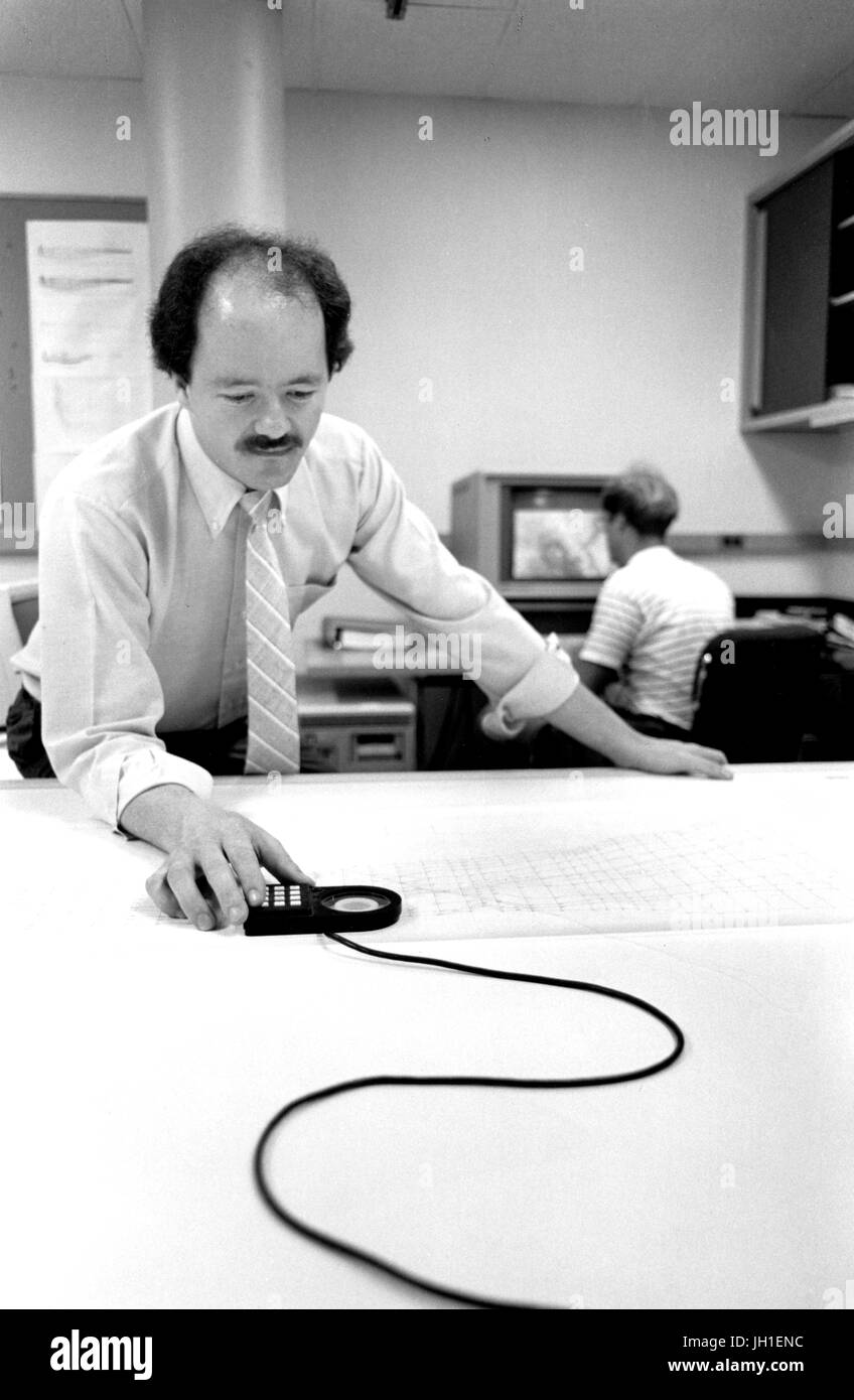 Candid portrait of geologist Grant Graven working with equipment in a laboratory, 1984. Stock Photo