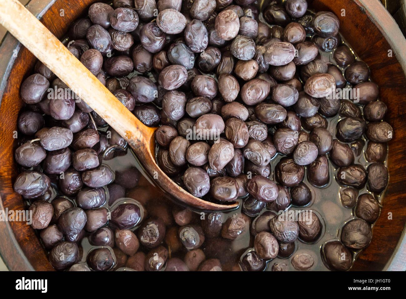 Olives in wooden bowls with serving spoon Stock Photo - Alamy