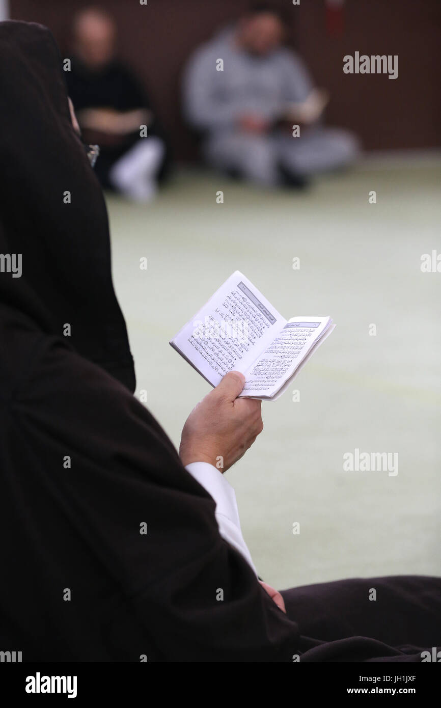Man reading the Quran in a mosque.  France. Stock Photo