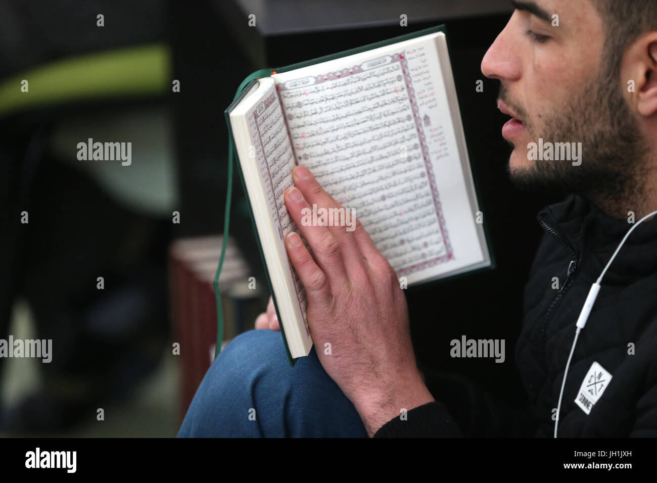 Man reading the Quran in a mosque.  France. Stock Photo