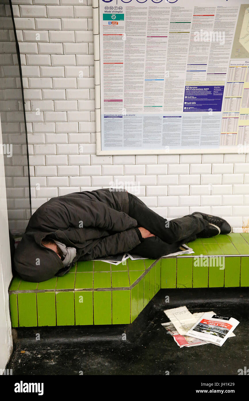 Homeless person sleeping in a Paris subway station. France. France. Stock Photo