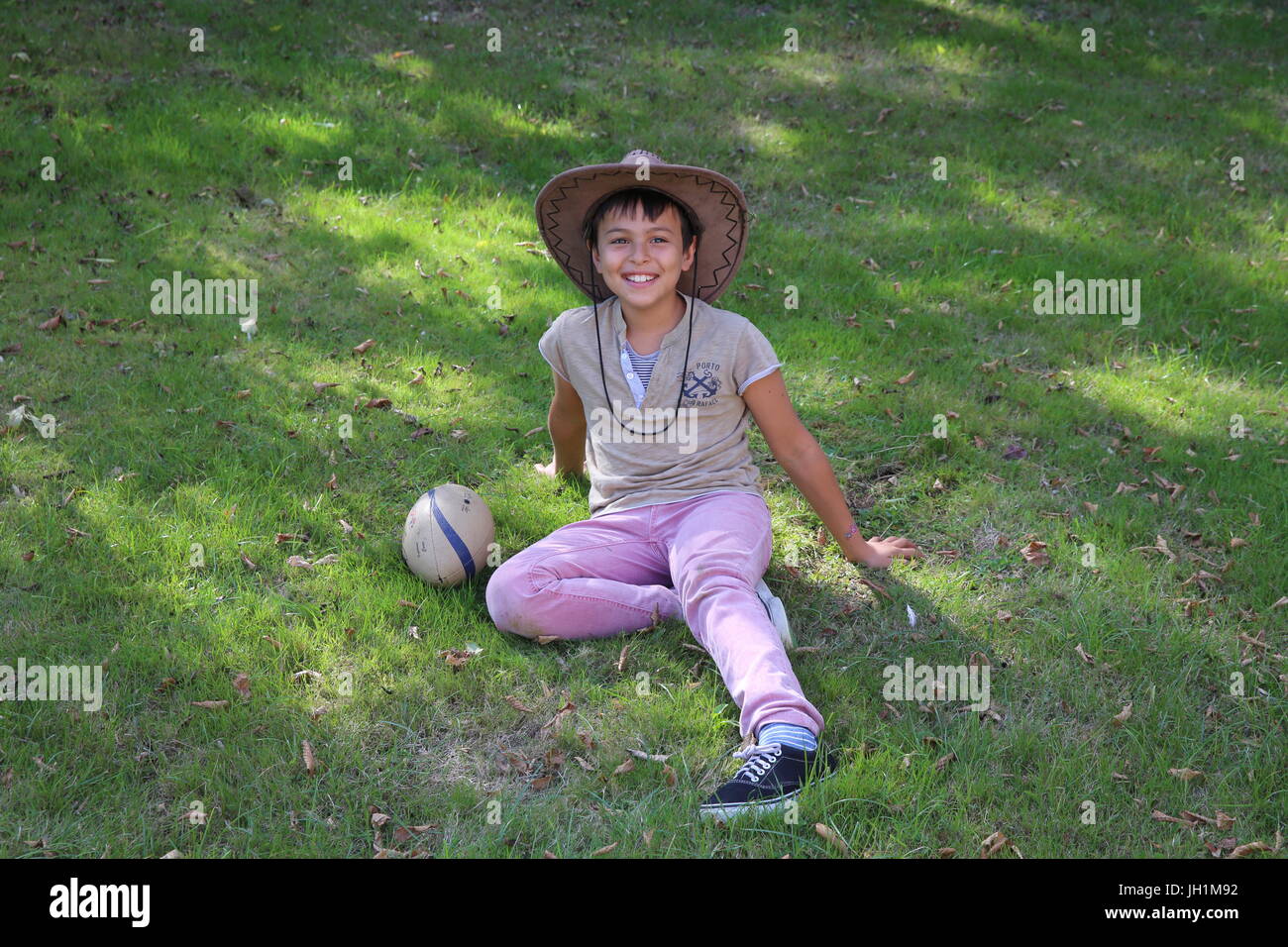 10 year old Boy Sitting In A Garden France Stock Photo Alamy