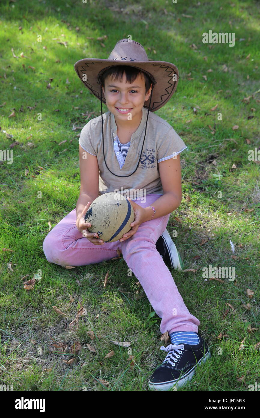 10-year-old boy holding a ball. France. Stock Photo