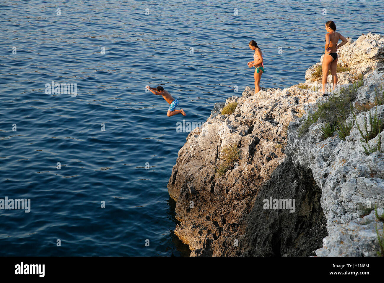 Boy jumping into the Med. Italy. Stock Photo