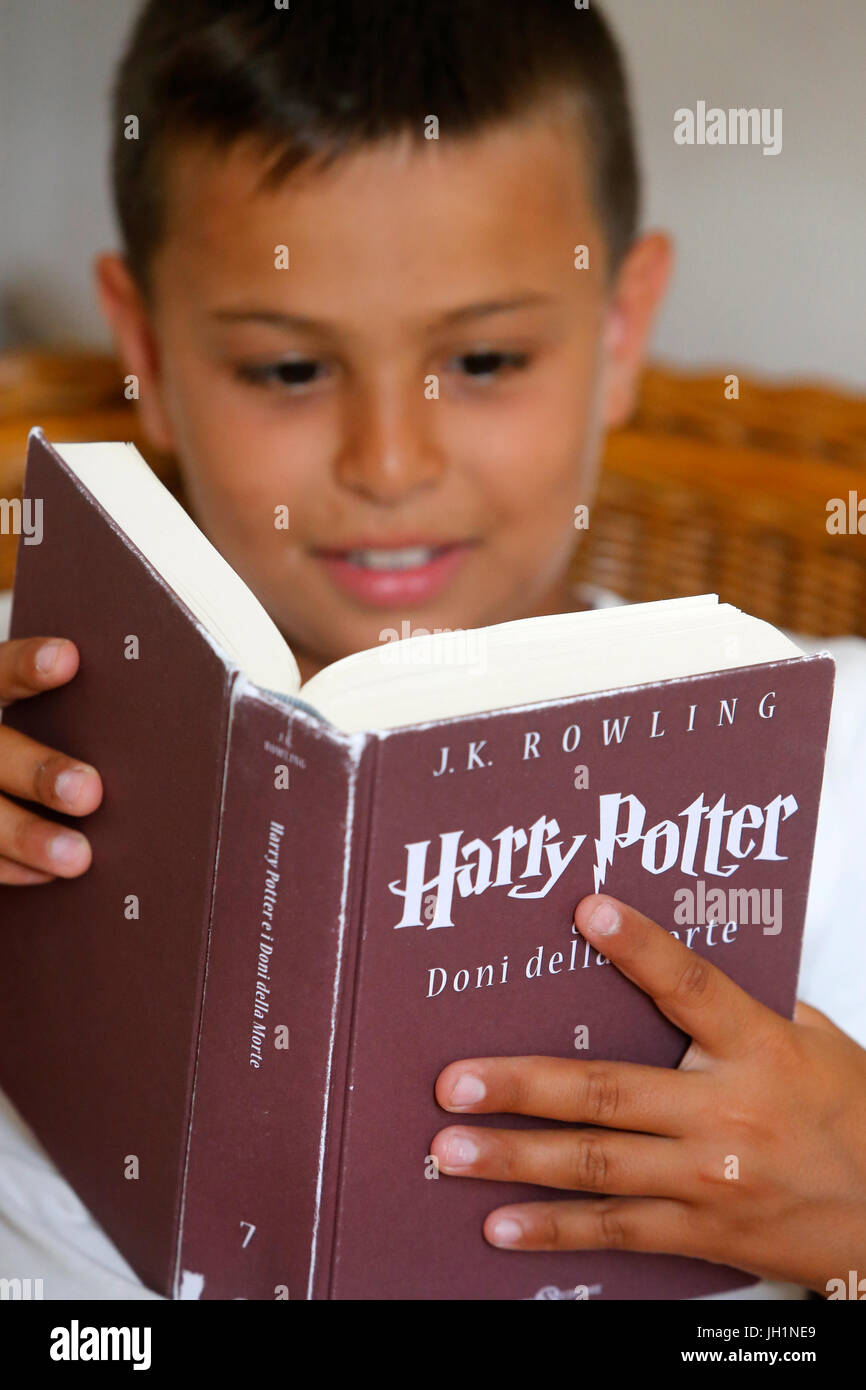 Boy reading Harry Potter. Italy. Stock Photo