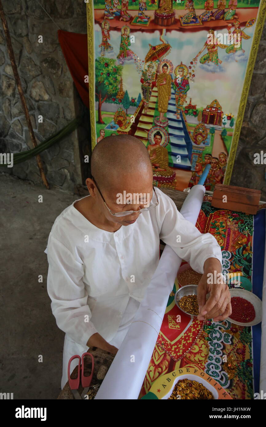 Buddhist nun making traditional craft. Cambodia. Stock Photo
