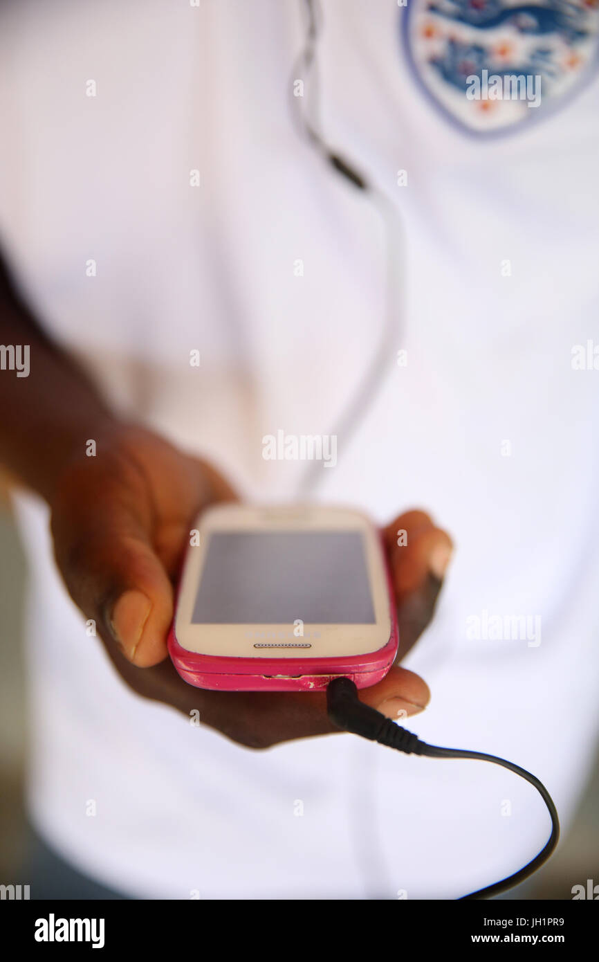 African boy using a smart phone.     Lome. Togo. Stock Photo