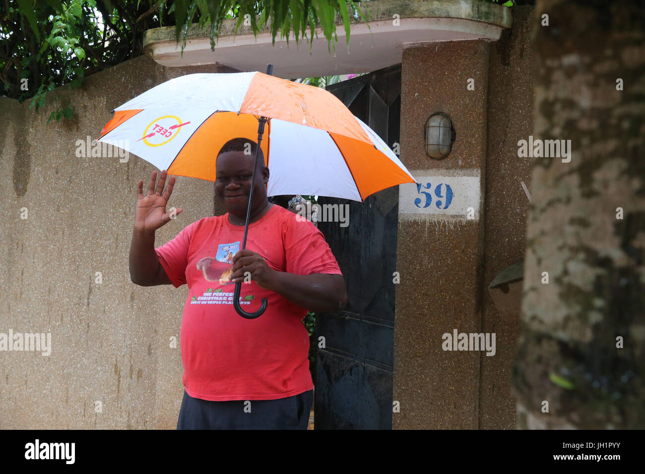 African boy with umbrella.  Lome. Togo. Stock Photo