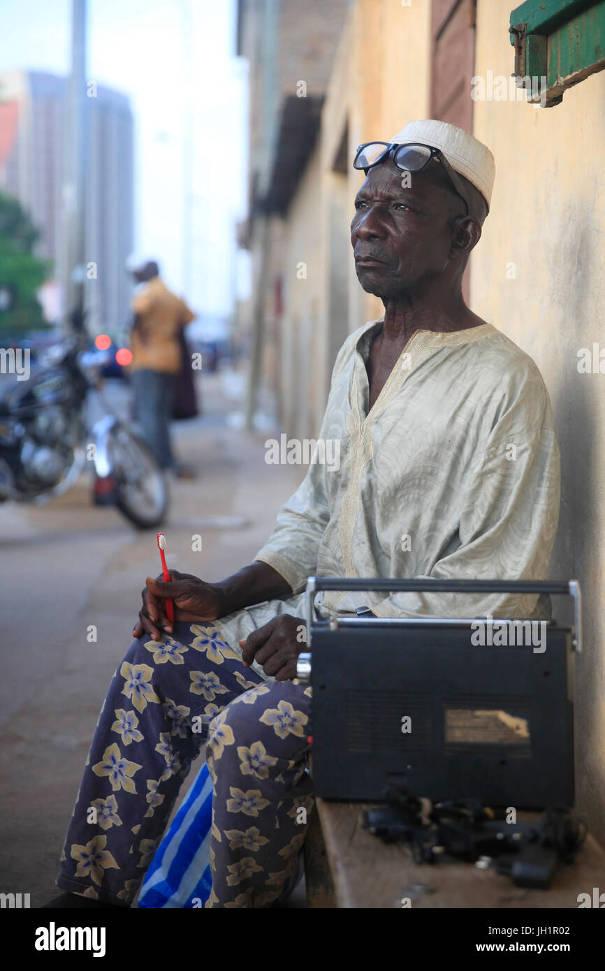 Old man listening to the radio. Lome. Togo Stock Photo - Alamy