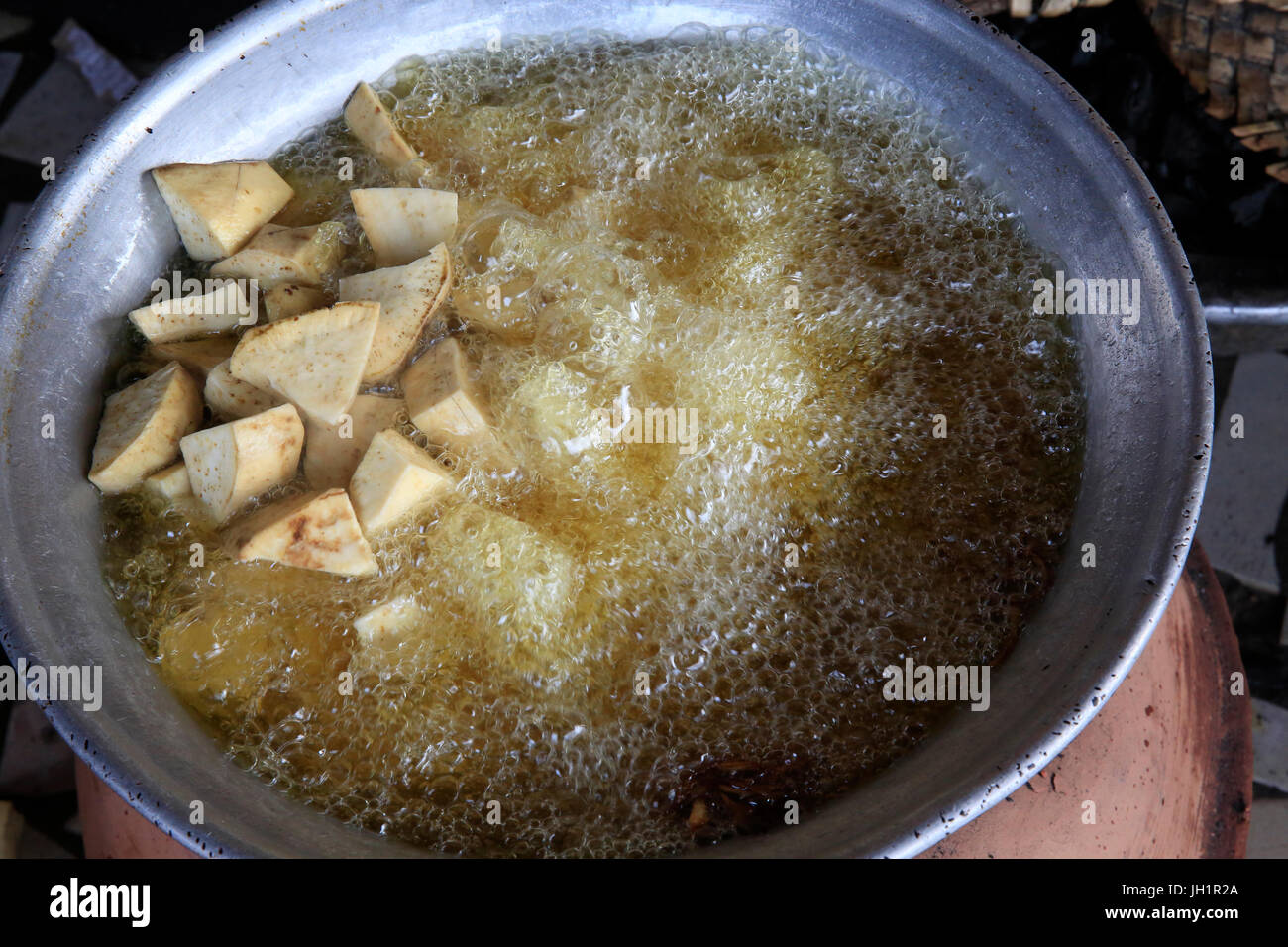African kitchen. Cassava cooking in oil. Lome. Togo Stock Photo Alamy