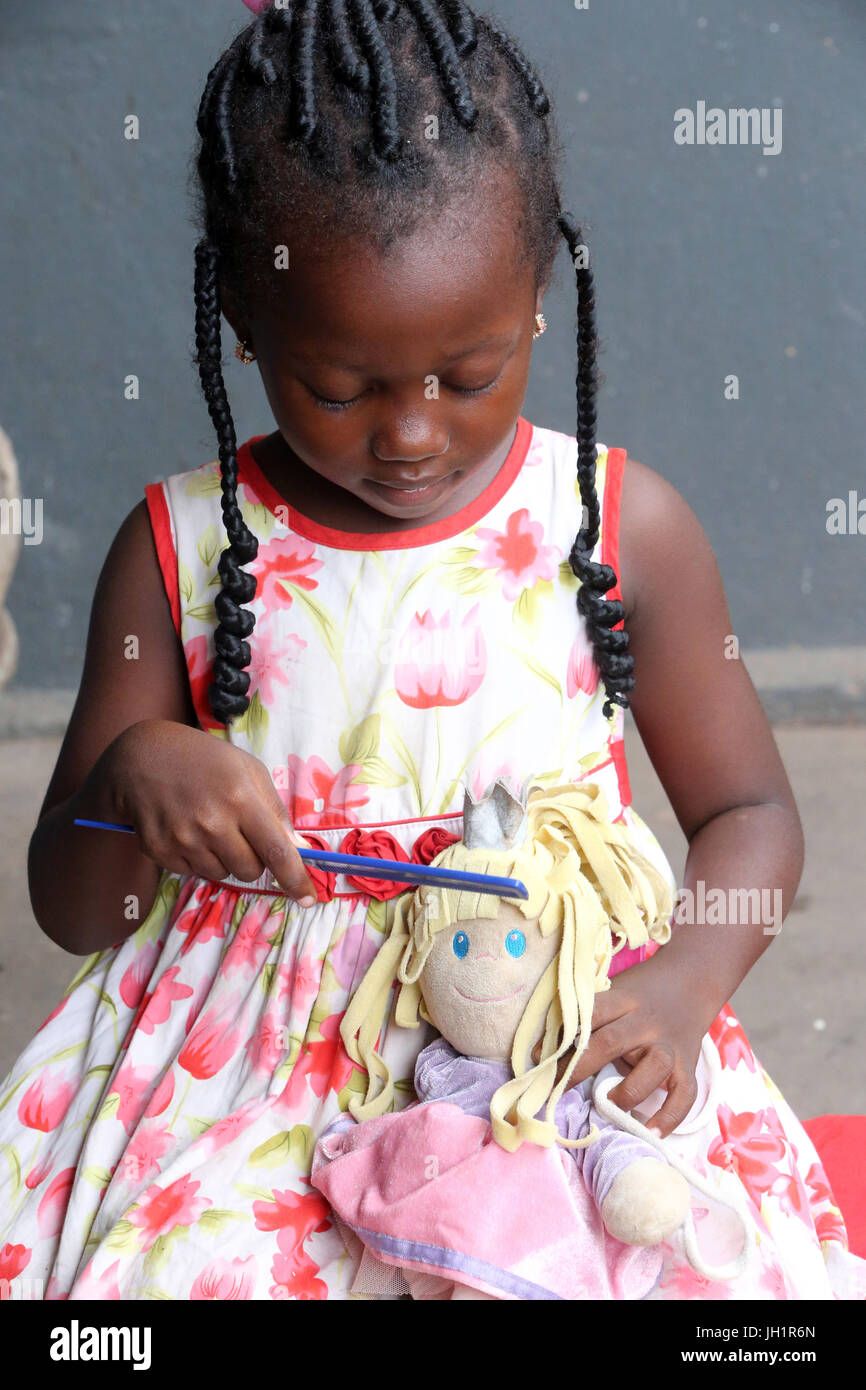 Girl playing with doll africa doll hi-res stock photography and images ...