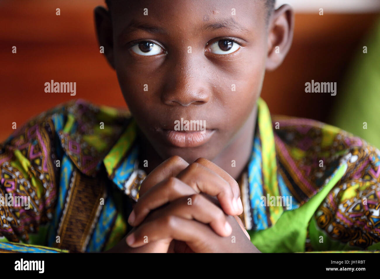 Sunday morning catholic mass.  Young boy praying.  Lome. Togo. Stock Photo