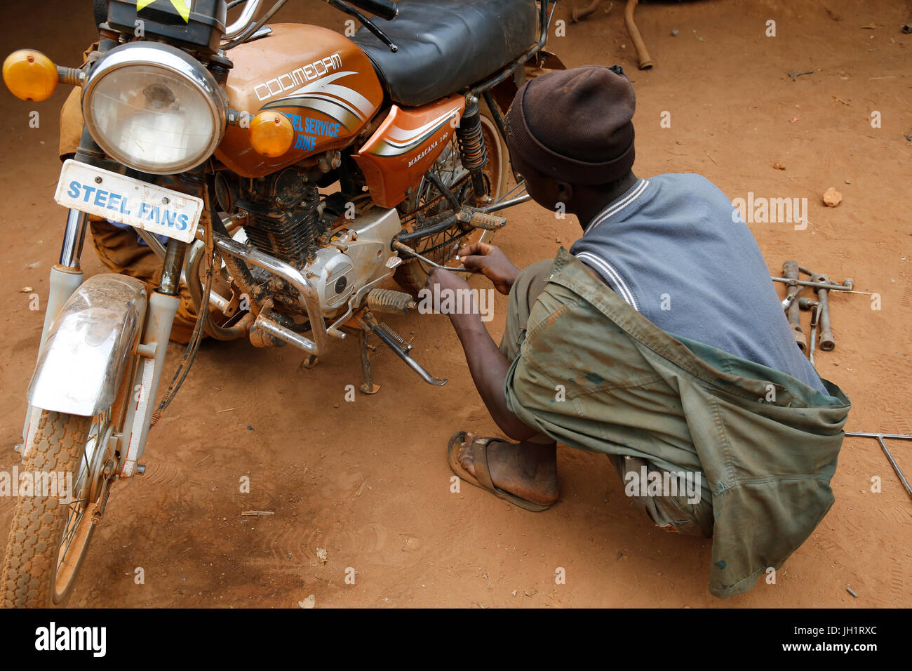 Apprentice working in a garage financed with a loan from ENCOT microfinance. Uganda. Stock Photo
