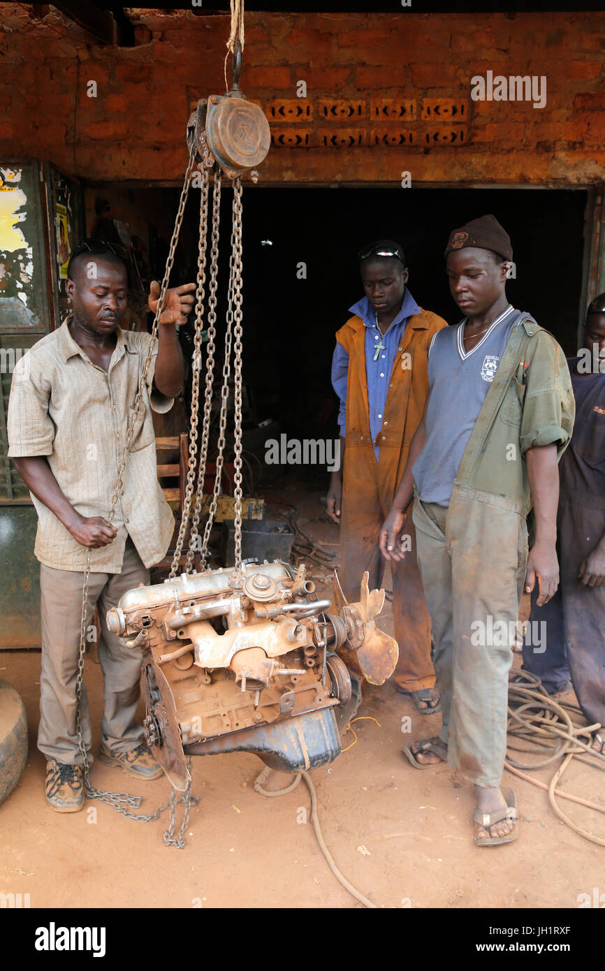 Mechanics working in a garage financed with a loan from ENCOT microfinance. Uganda. Stock Photo