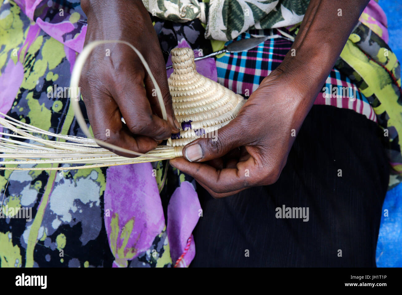 ENCOT microfinance client making a rattan basket. Uganda. Stock Photo