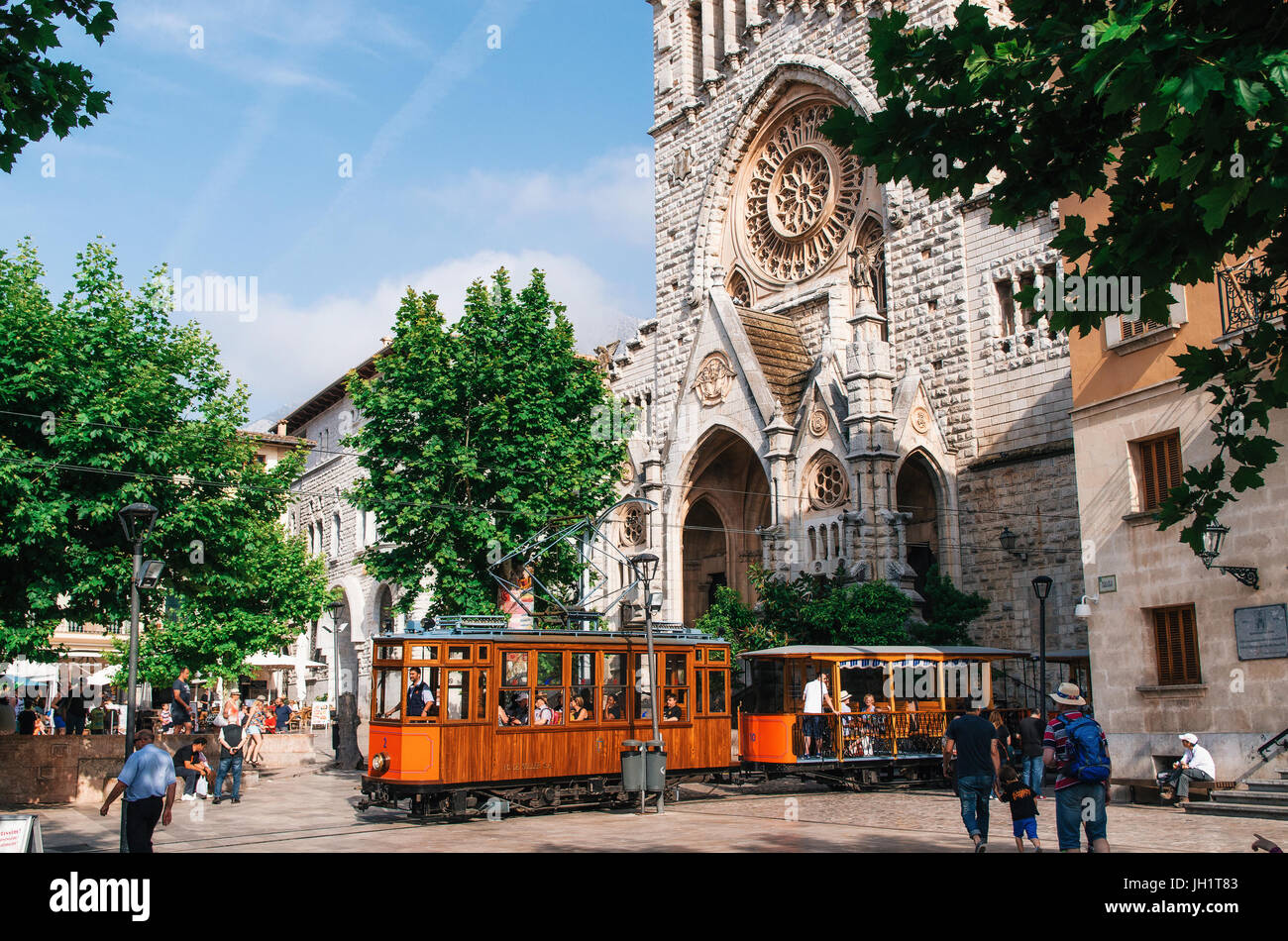 Port de Soller, Mallorca, Spain - May 26, 2016: Old tram in Soller in front of medieval gothic cathedral with huge rose window, Mallorca, Spain Stock Photo