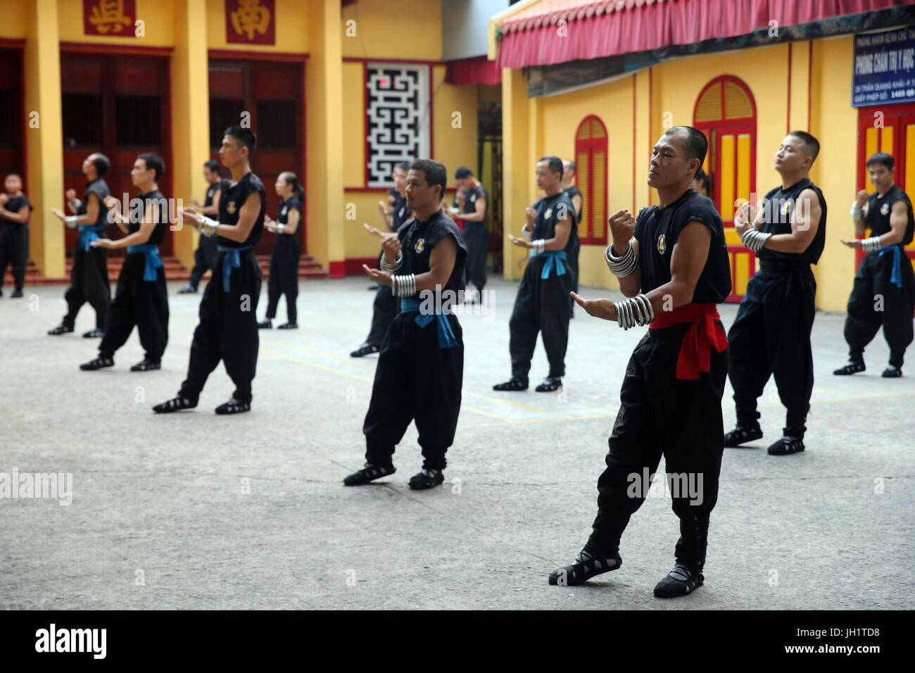 Men practicing martial arts in a buddhist temple.  Ho chi Minh City. Vietnam. Stock Photo