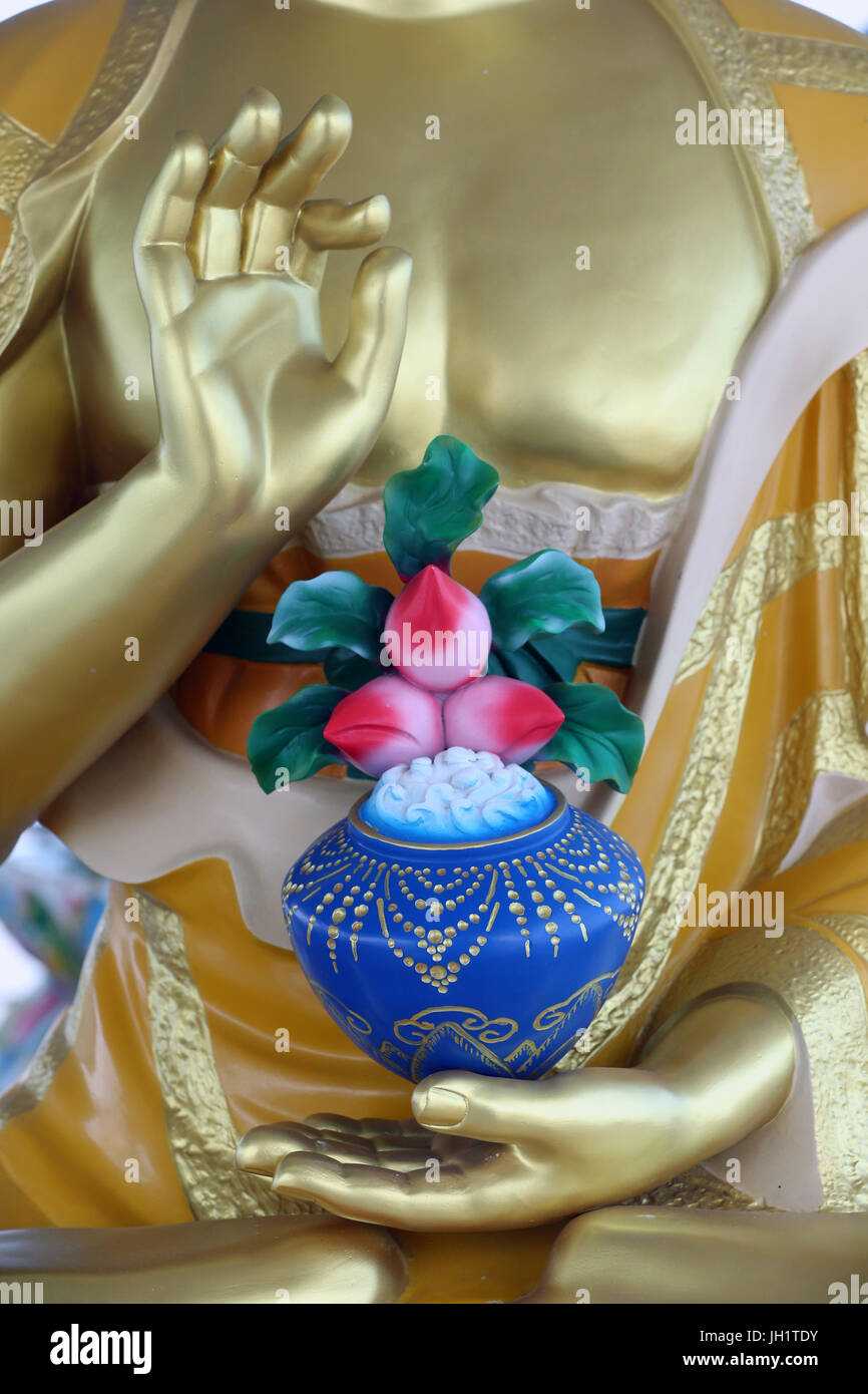 Golden Buddha statue. Mudra with lotus flowers.  Vung Tau. Vietnam. Stock Photo