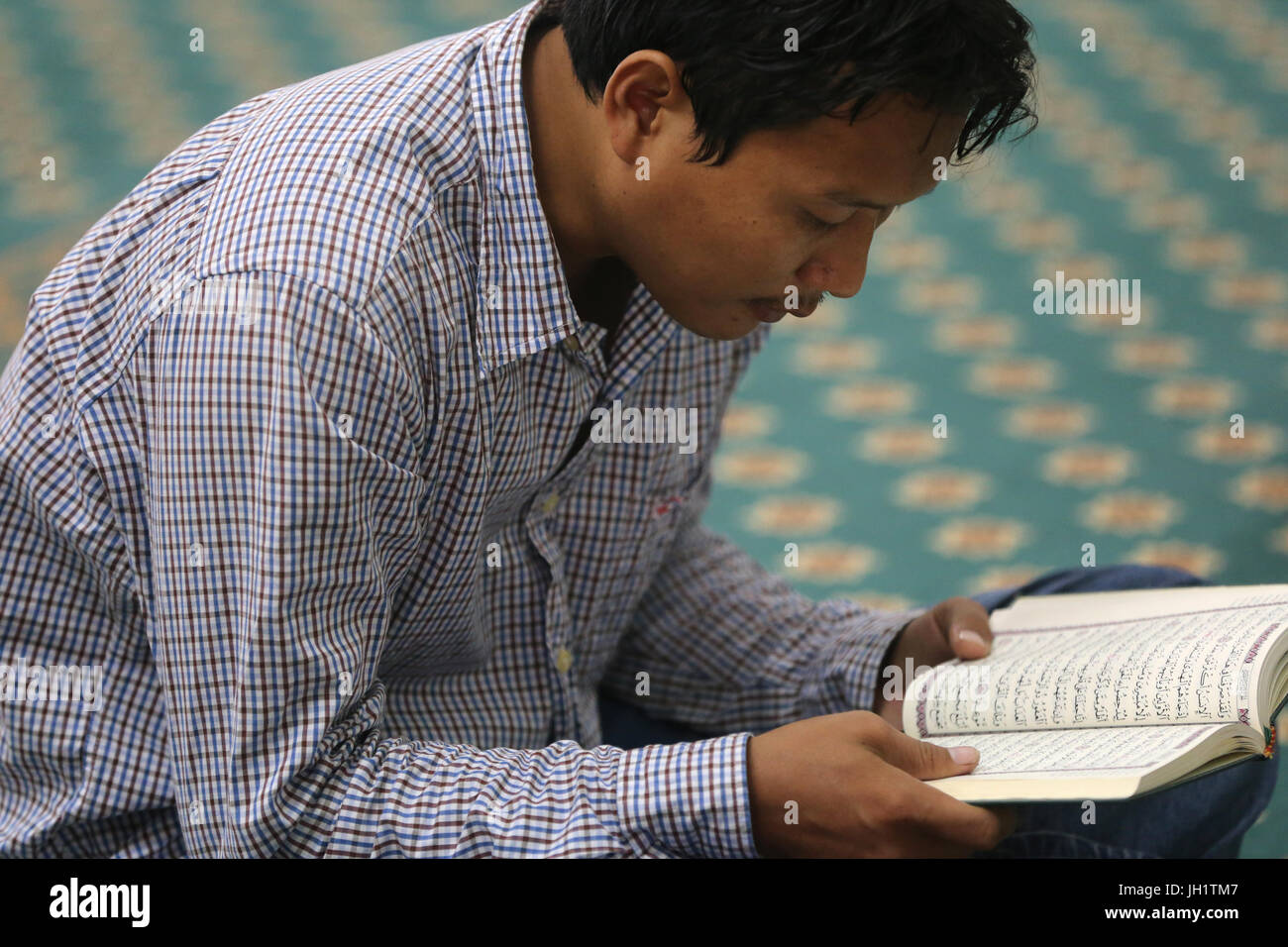 Masjid Musulman (Saigon Central Mosque). Man reading the holy Quran. Ho chi Minh City. Vietnam. Stock Photo