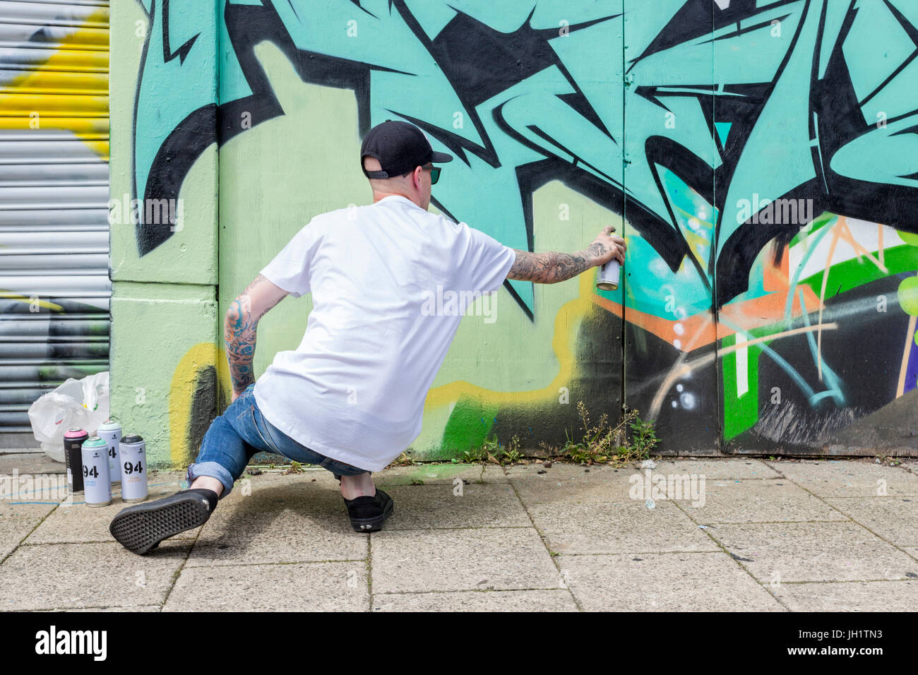 Graffiti artist spray painting a wall, Nottingham, England, UK Stock Photo  - Alamy