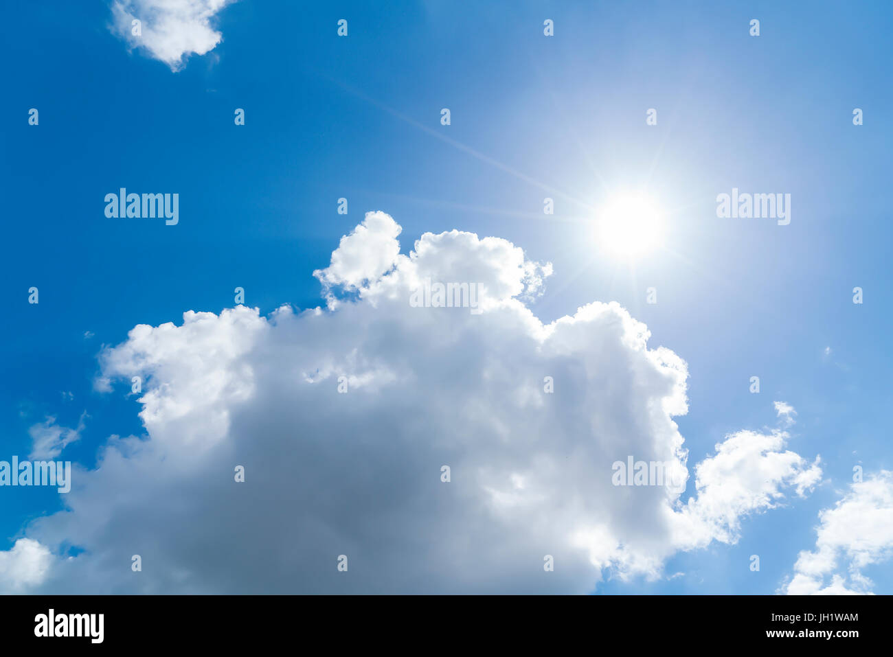 cloudscape with blue sky and sun for backgrounds Stock Photo - Alamy